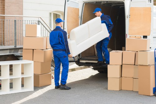 Moving team handling flat removals in Kilburn outside a residential building