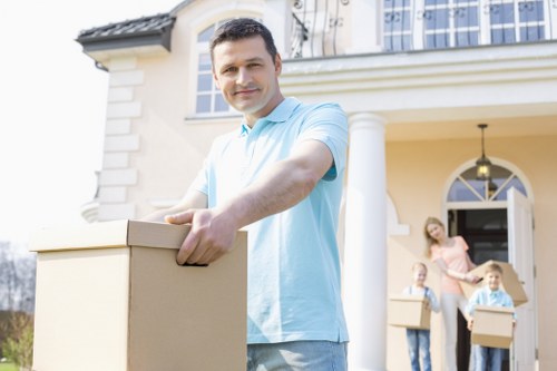 House removals planning in Kilburn with moving boxes and careful organisation